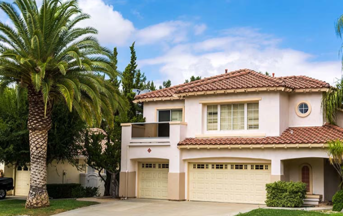 fullerton, ca light clay colored home with palm trees on the left